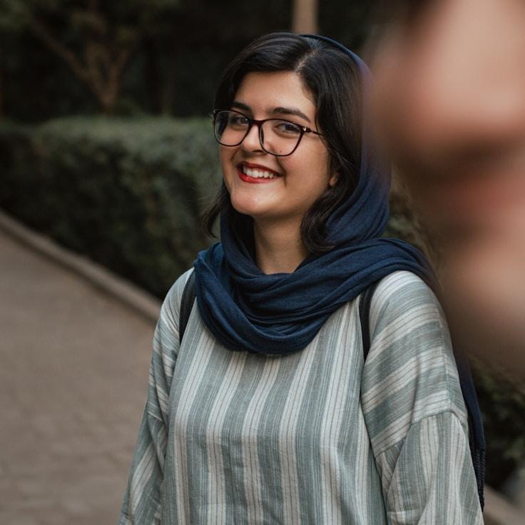 Alexis Chen, Lead Design Curator at Echo Isle Paper, reviewing corporate floral arrangements